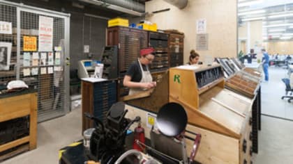 People using the letterpress at Central Saint Martins