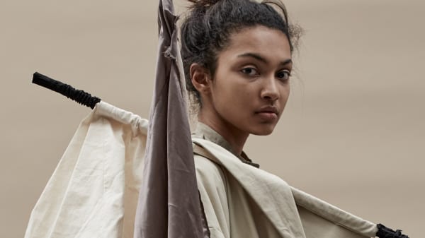 Model's head and neck in profile wearing a structured cream and brown outfit from BA18