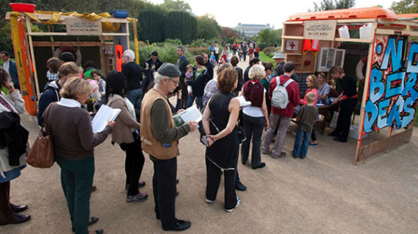 Photo of a group of people queueing outside a booth