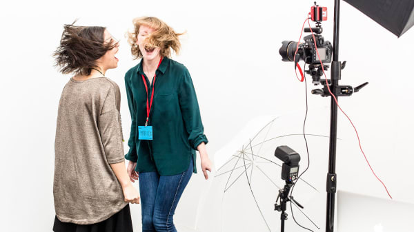 Two laughing girls in a photography studio