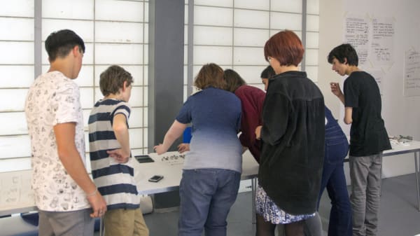 students gathered around a desk