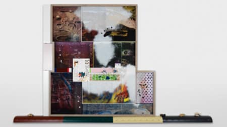 A collage of photographs and different imagery presented against a white wall