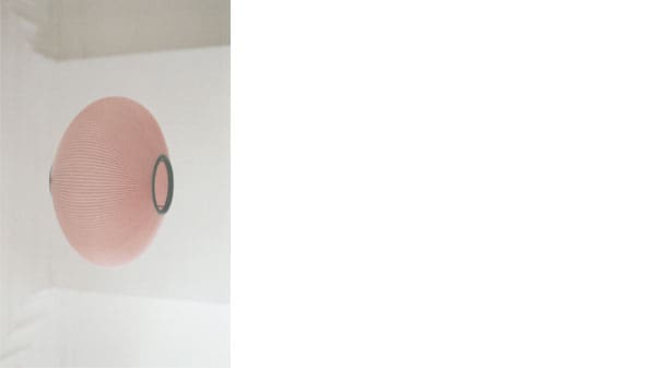 A pink paper lamp on its side