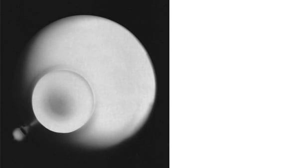 A white spherical object on a black background