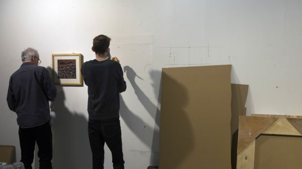 Students learning to install an exhibition