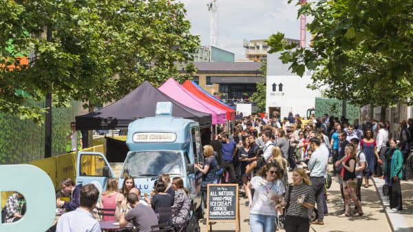 A busy street lined with different vans selling food