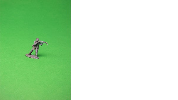 An army figurine on a green background