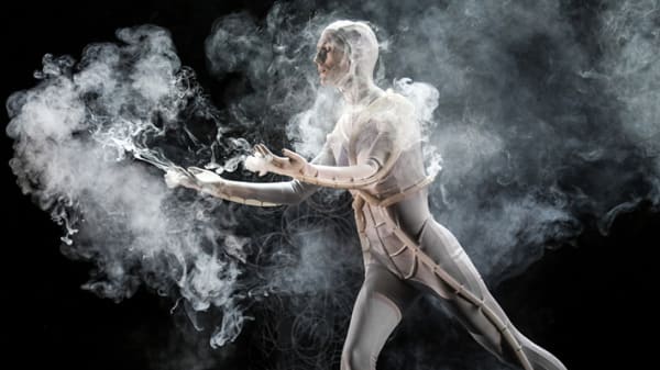 Photo of a man in a costume surrounded by smoke