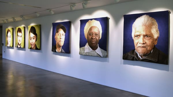 Installation photo of local portraits in the Faisal Abdu'Allah exhibition Facets of a community