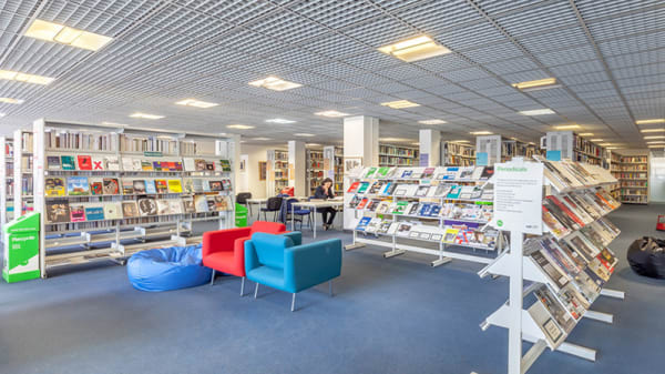 Rows of books and seated area at LCC Library