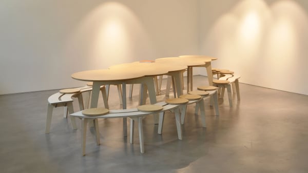 Table and chairs in the On the Way to Language exhibition