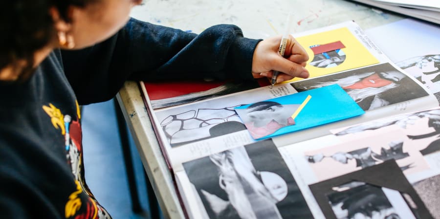Student adding notes to a sketchbook