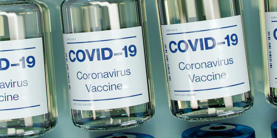a number of small glass jars labelled vaccine