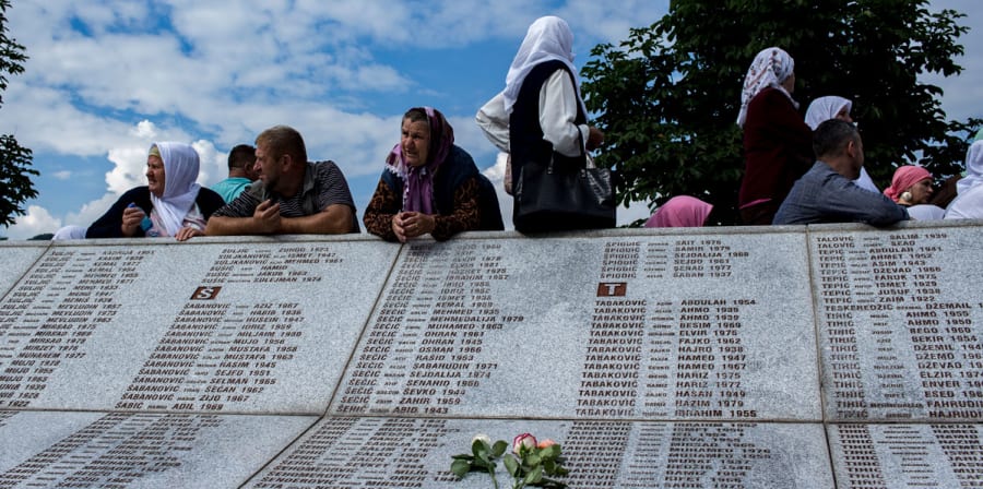 old women sitting on memorial