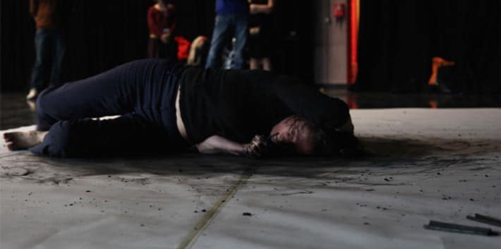 A performance artist moving on the ground