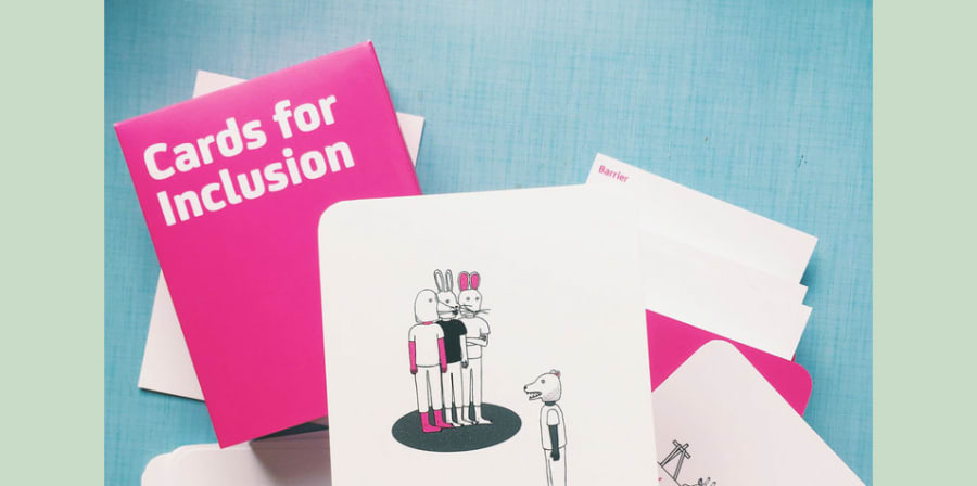 Paper cards showing visual representation of inclusive language in art setting