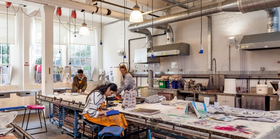 Students in Lime Grove's print workshop with print works on high table tops