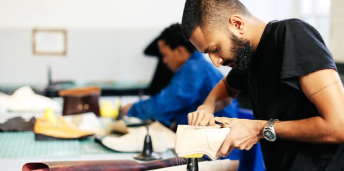 Male student working on a footwear project