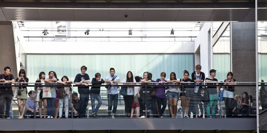 A row of people stood on the top floor inside Central Saint Martins