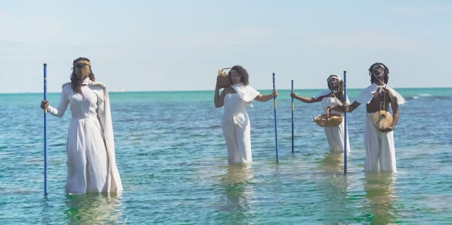 women in white standing in the. sea