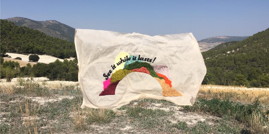Embroidered flag in the winderness by Bronwyn Seier - Almeria, Spain
