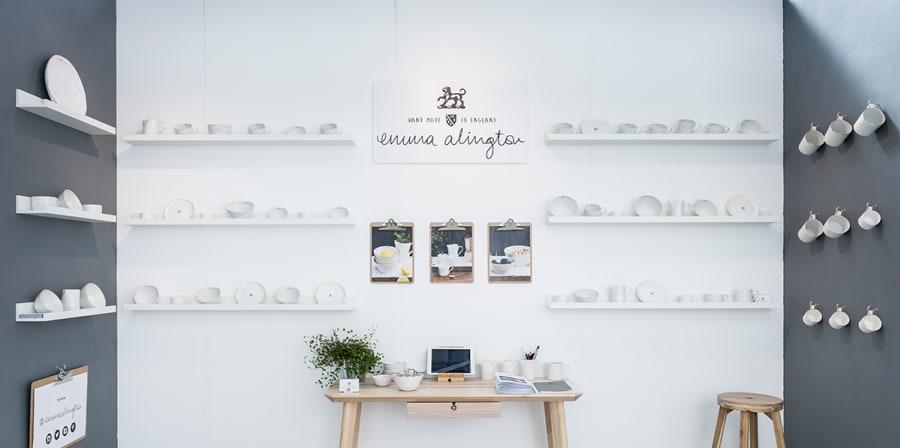 Exhibition space with white ceramic cups on display.