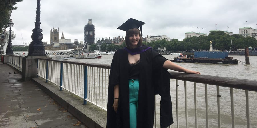 Hannah stands on the South Bank after graduating from LCC.