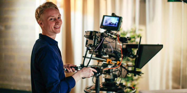 UAL alumin behind a video camera