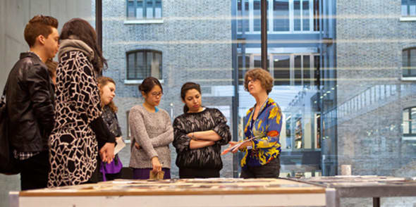 A group of people looking at someone holding a piece of paper
