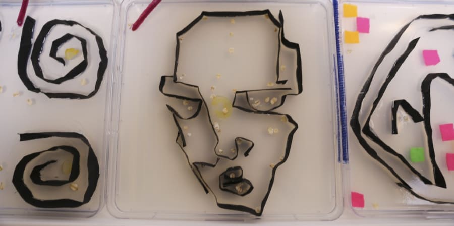 Figures made out of different materials displayed on a white table