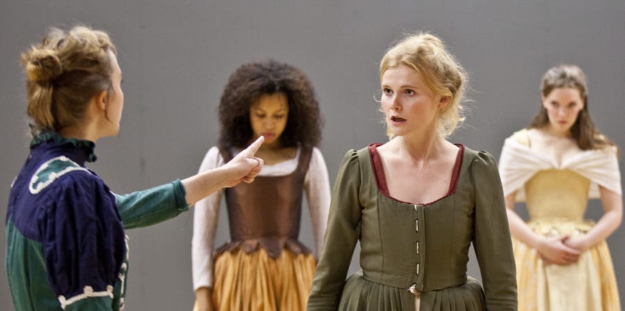 Drama students rehearsing wearing period costumes