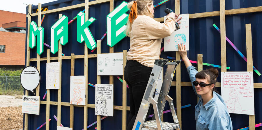 Exterior of Make space with people on ladders