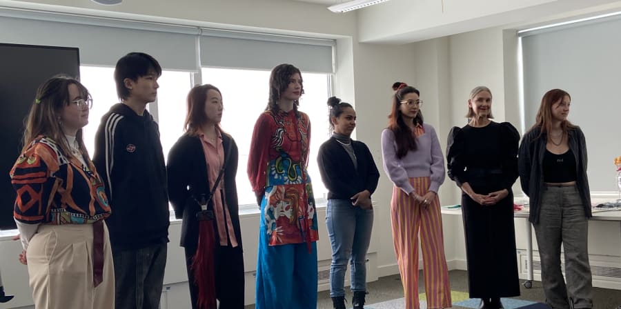 8 student finalists stand in a line at the Grayson's Robes competition pitch