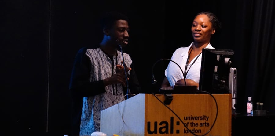 Mariama Wurie and another participant stand at the lectern