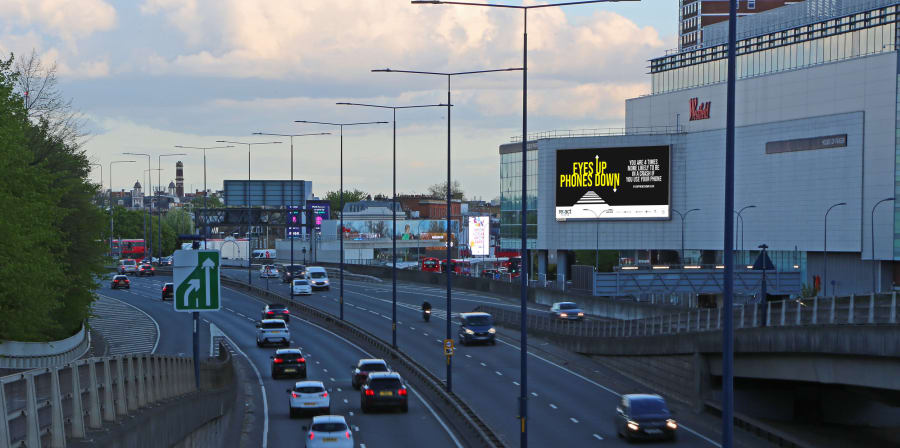 Image on a screen over a busy motorway