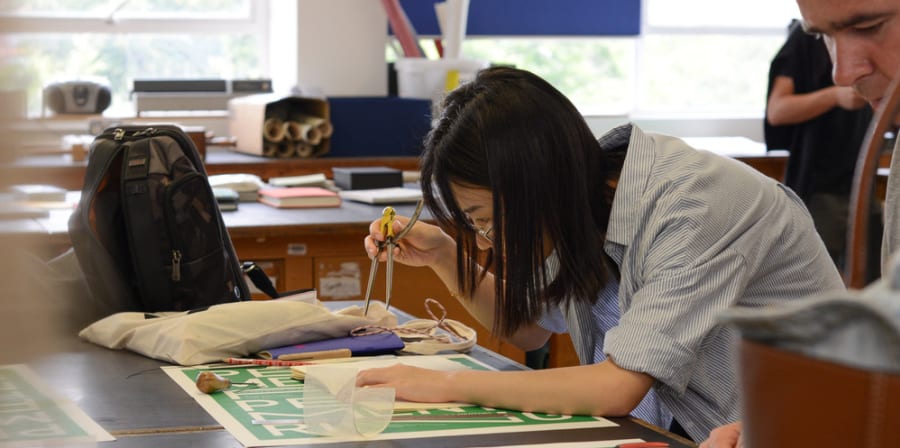 Student Working with typography, Bookmaking Workshop. Decorative image only.