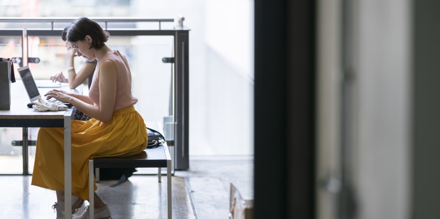 Student in yellow dress studying at a desk