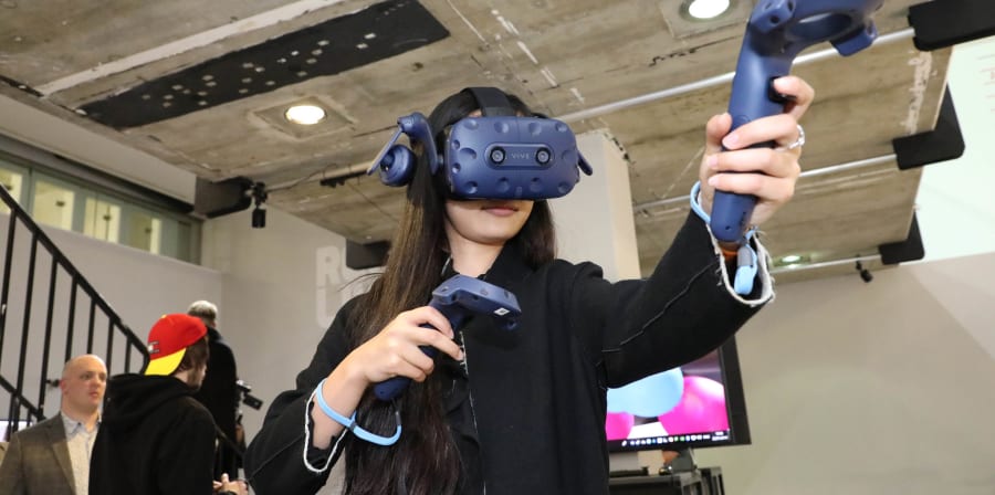 Woman wearing VR headset pointing
