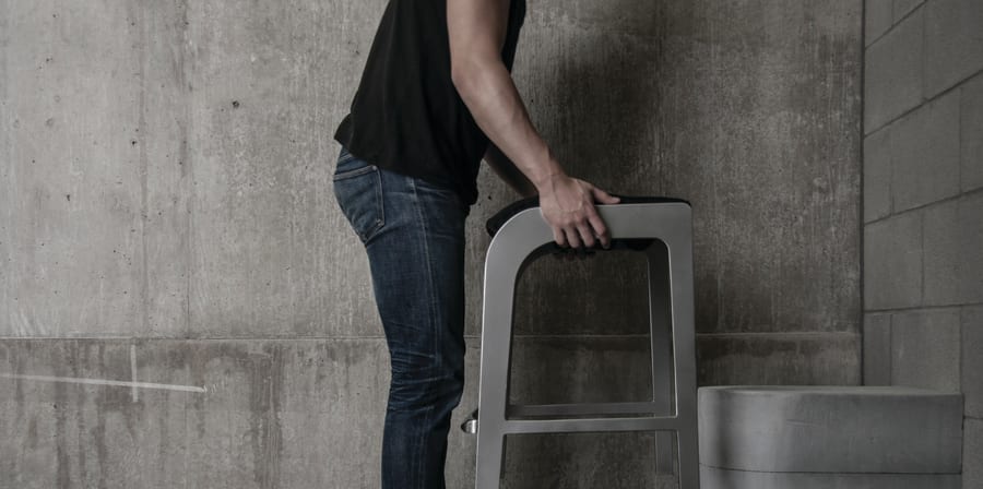 Man holding furniture over toilet
