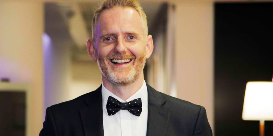 Man in suit smiling