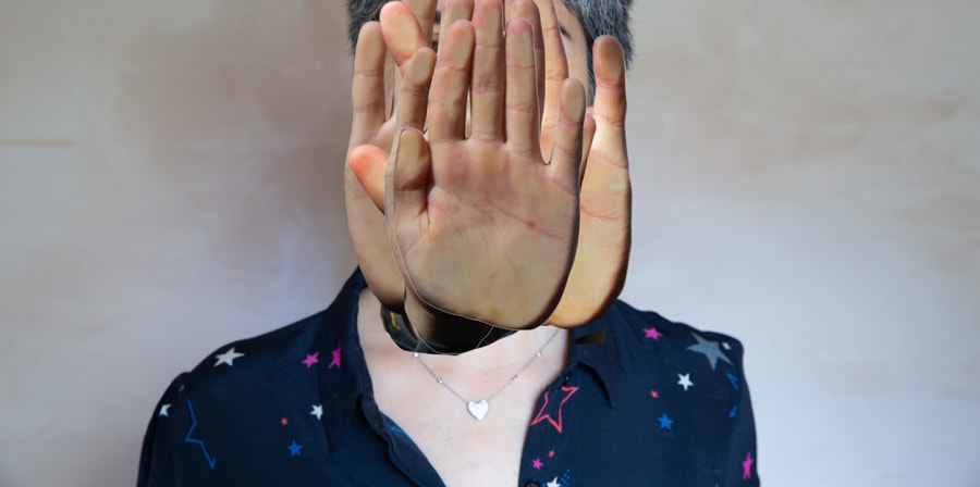 Photograph of a woman with hands collaged over her face