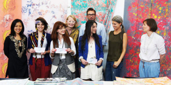 A group of people stood in front of a brightly coloured backdrop
