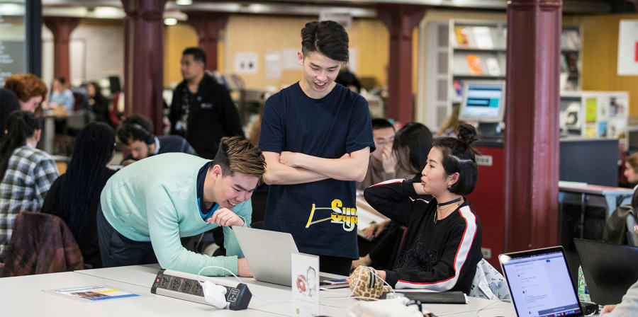 Students discussing in the library