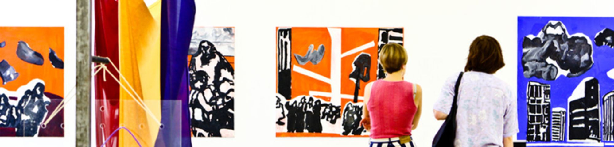 Two people looking at artwork