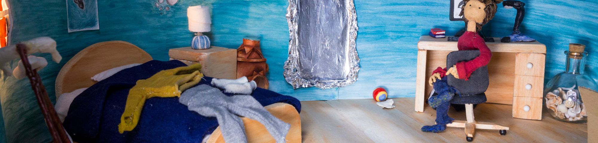 Plasticine model of a person in a bedroom