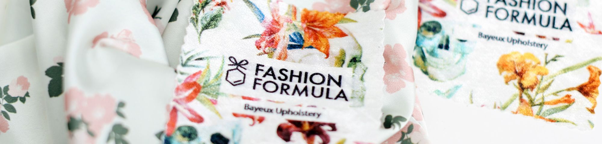 Piece of colourful material on a table with 'Fashion Formula' printed on the label