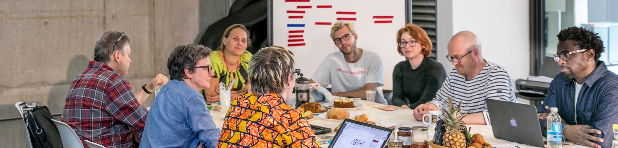 Group of people sitting around a table in discussion