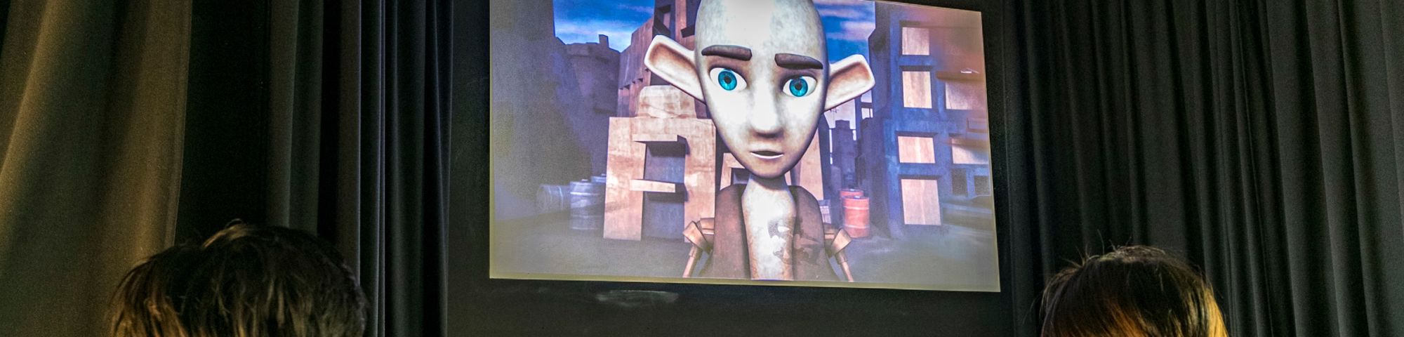 People watching the screening of an animated film