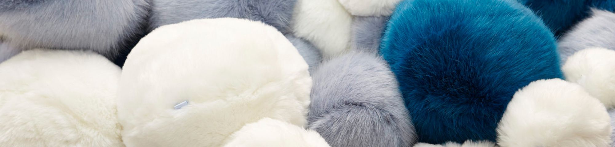 Close-up shot of blue, white and grey fluffy balls