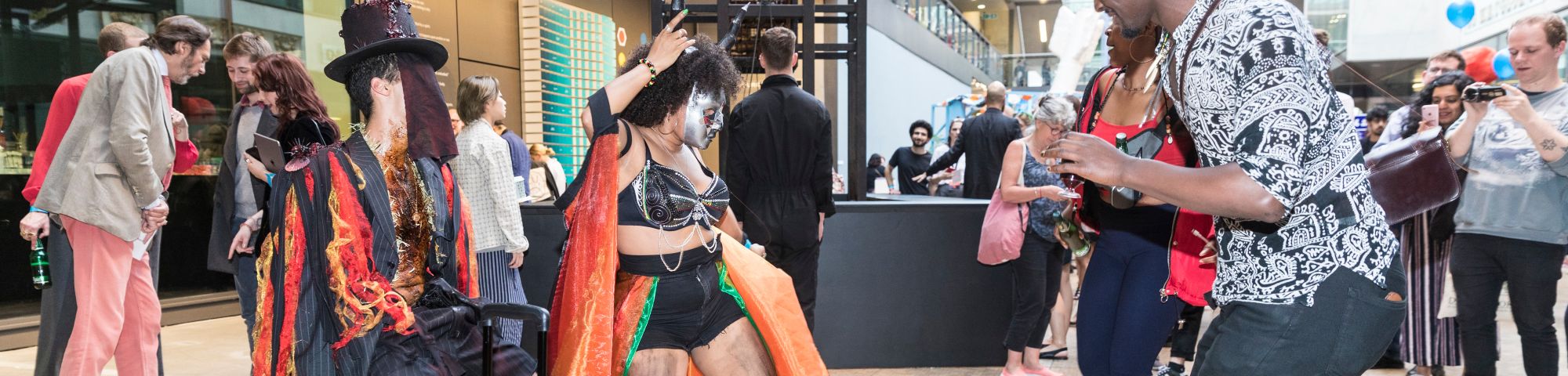 People dancing wearing carnival inspired clothing.